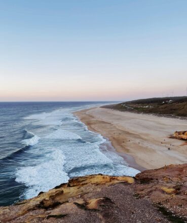 Breathtaking view of the Atlantic coastline in Nazaré, Portugal during sunset.
